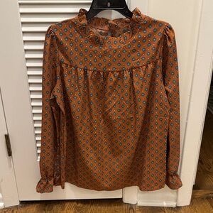 Gently use brown top with blue and white patterns